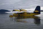 A picture of a yellow and blue Grumman Widgeon on the water